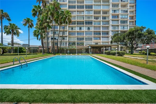 a swimming pool with outdoor seating and yard