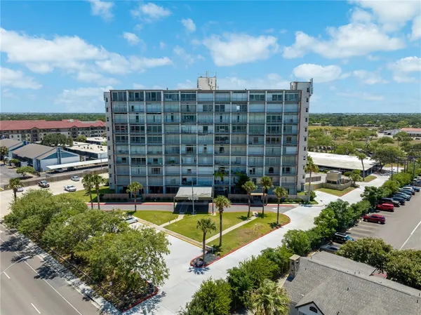a view of swimming pool with outdoor seating and a garden
