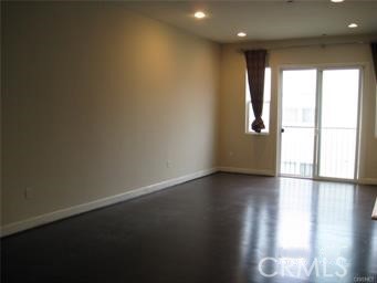 10878 Bloomfield Street, Unit 404 Toluca Lake, CA 91602 - Photo 12 of 36 a view of empty room with wooden floor and fan