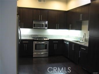 10878 Bloomfield Street, Unit 404 Toluca Lake, CA 91602 - Photo 13 of 36 a kitchen with a sink and a stove