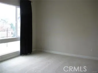 a view of an empty room and a window