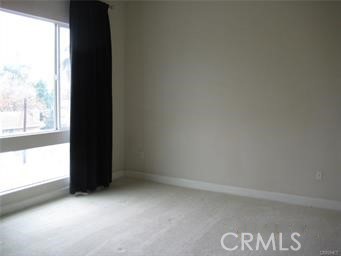 10878 Bloomfield Street, Unit 404 Toluca Lake, CA 91602 - Photo 19 of 36 a view of an empty room and a window