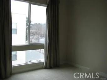 a view of an empty room and a window