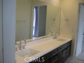 10878 Bloomfield Street, Unit 404 Toluca Lake, CA 91602 - Photo 30 of 36 a bathroom with a sink and a mirror