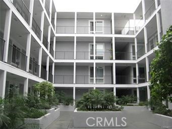 10878 Bloomfield Street, Unit 404 Toluca Lake, CA 91602 - Photo 6 of 36 a front view of a building with a yard