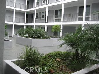 10878 Bloomfield Street, Unit 404 Toluca Lake, CA 91602 - Photo 7 of 36 a front view of a house with a garden