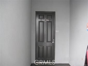 10878 Bloomfield Street, Unit 404 Toluca Lake, CA 91602 - Photo 10 of 36 a view of a hallway with wooden floor