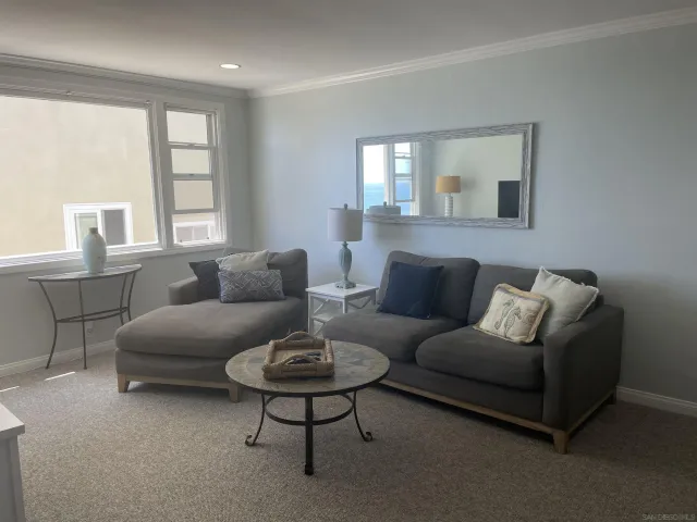a dining room with furniture and chandelier
