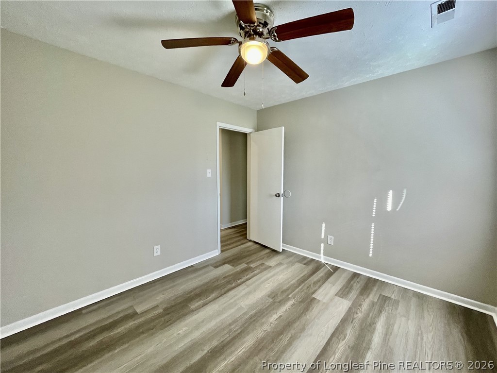 5985 McDonald Road Parkton, NC 28371 - Photo 13 of 20 an empty room with ceiling fan and window
