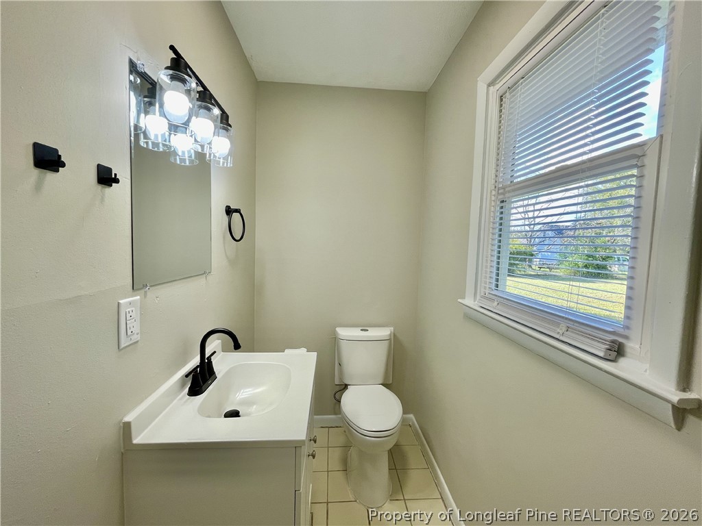 5985 McDonald Road Parkton, NC 28371 - Photo 19 of 20 a bathroom with a toilet sink and mirror