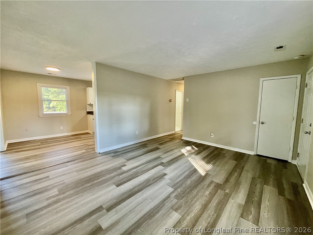 5985 McDonald Road Parkton, NC 28371 - Photo 3 of 20 a view of an empty room and wooden floor