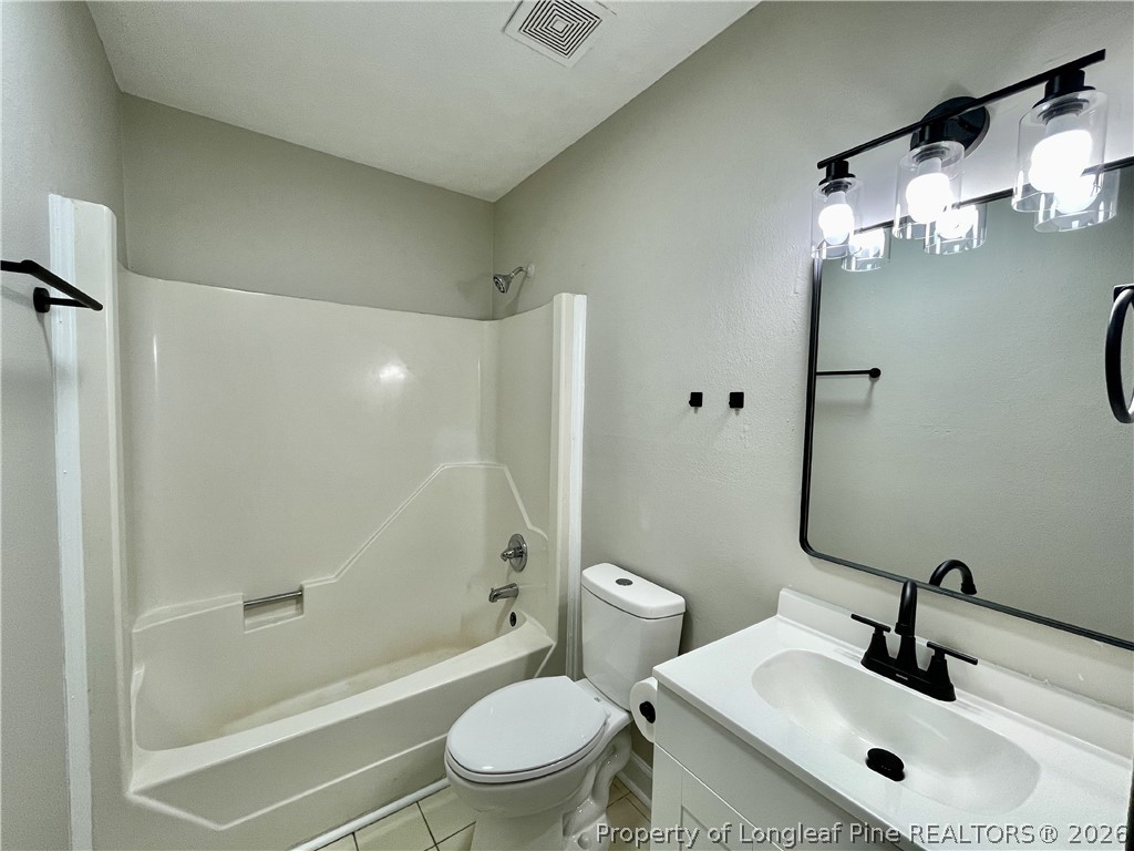 5985 McDonald Road Parkton, NC 28371 - Photo 10 of 20 a bathroom with a sink mirror bathtub and toilet