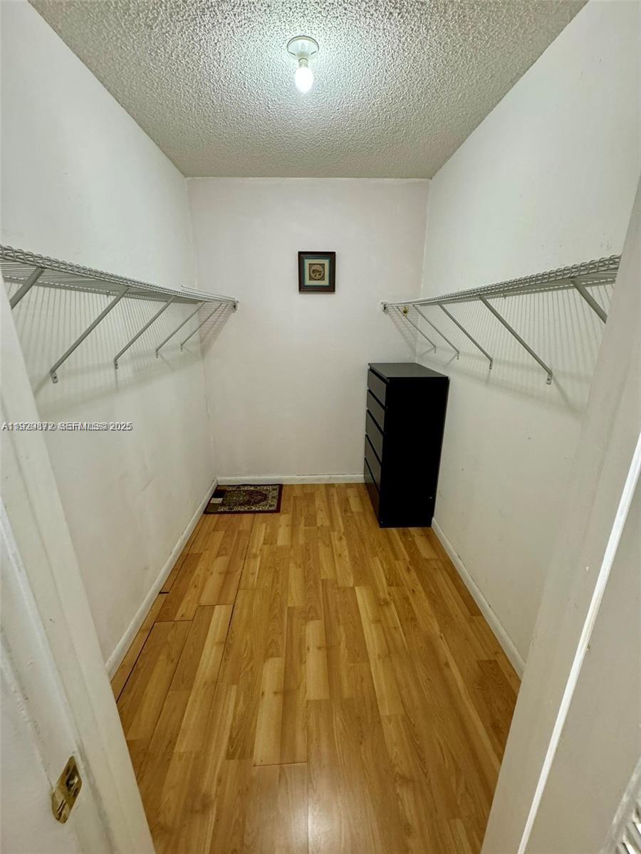 7060 Nova Drive, Unit 306C Davie, FL 33317 - Photo 12 of 17 a bedroom with a bed