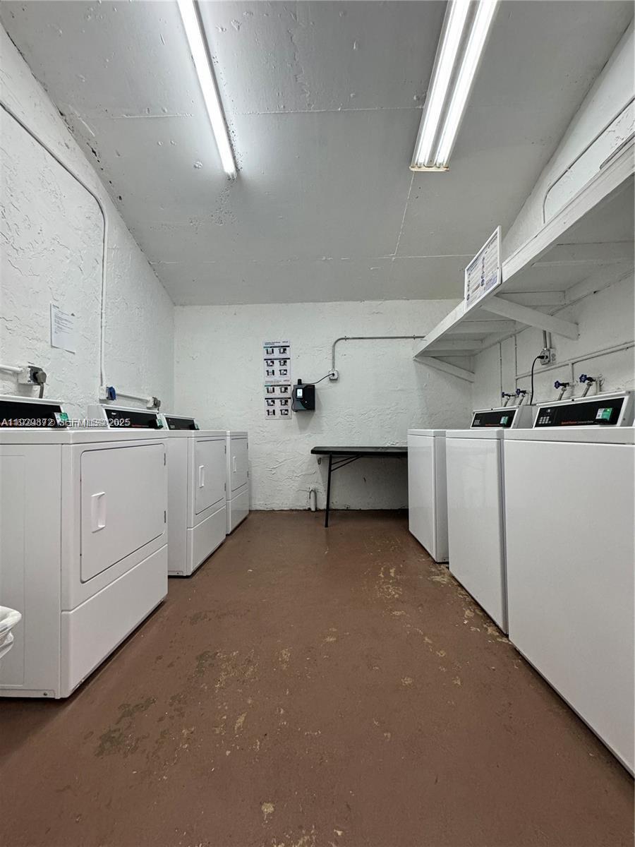 7060 Nova Drive, Unit 306C Davie, FL 33317 - Photo 16 of 17 a kitchen with cabinets and white appliances
