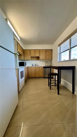 a kitchen with a refrigerator sink and microwave
