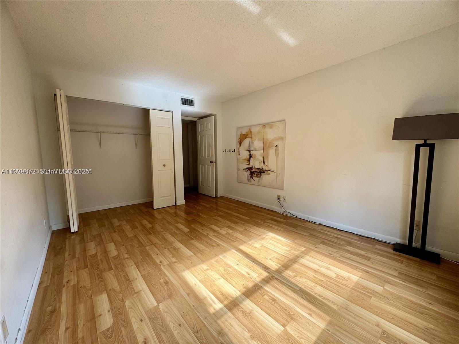 7060 Nova Drive, Unit 306C Davie, FL 33317 - Photo 8 of 17 a view of empty room with wooden floor