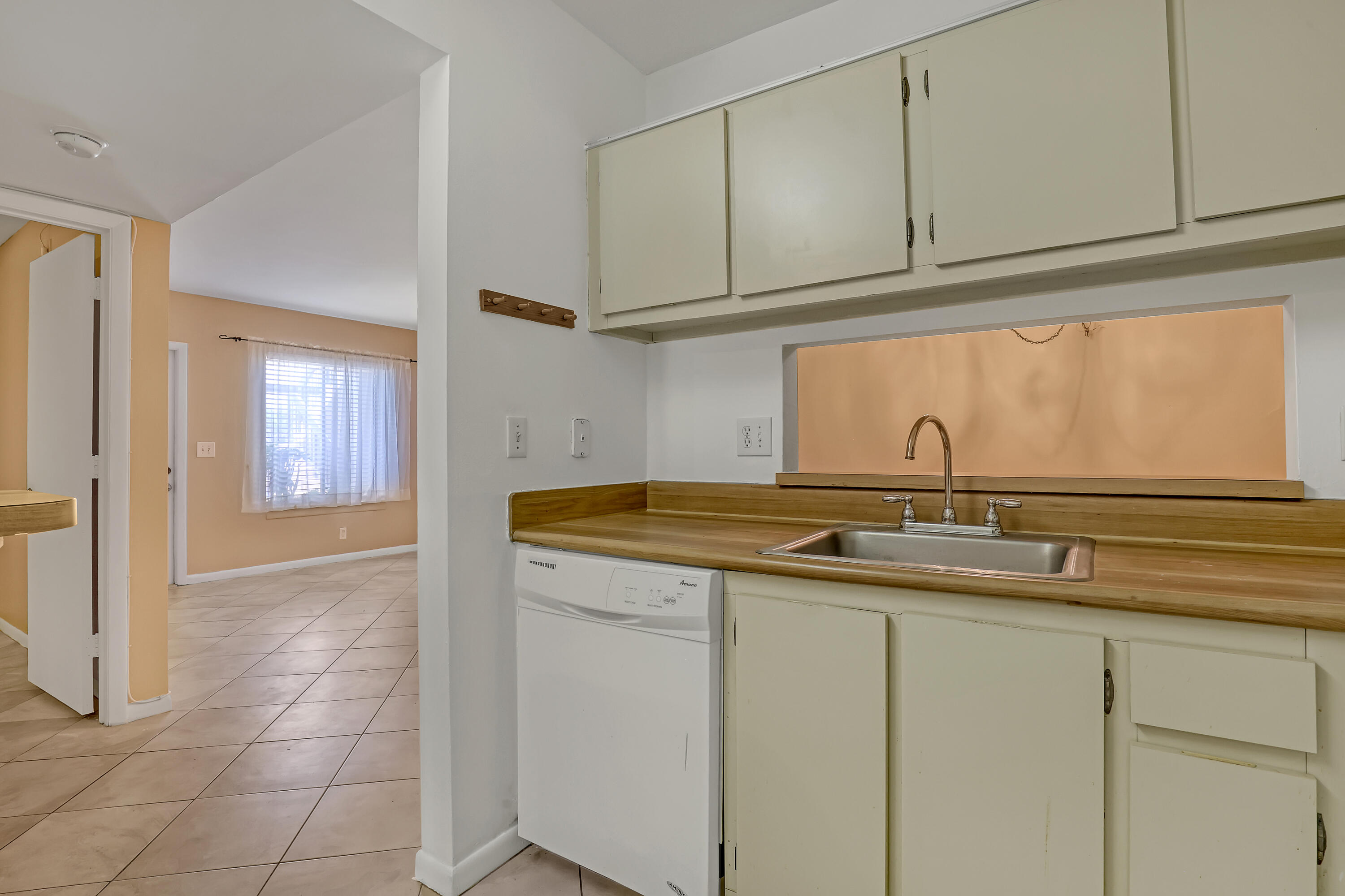6257 Chasewood Drive, Unit B Jupiter, FL 33458 - Photo 14 of 36 a kitchen with a sink and cabinets