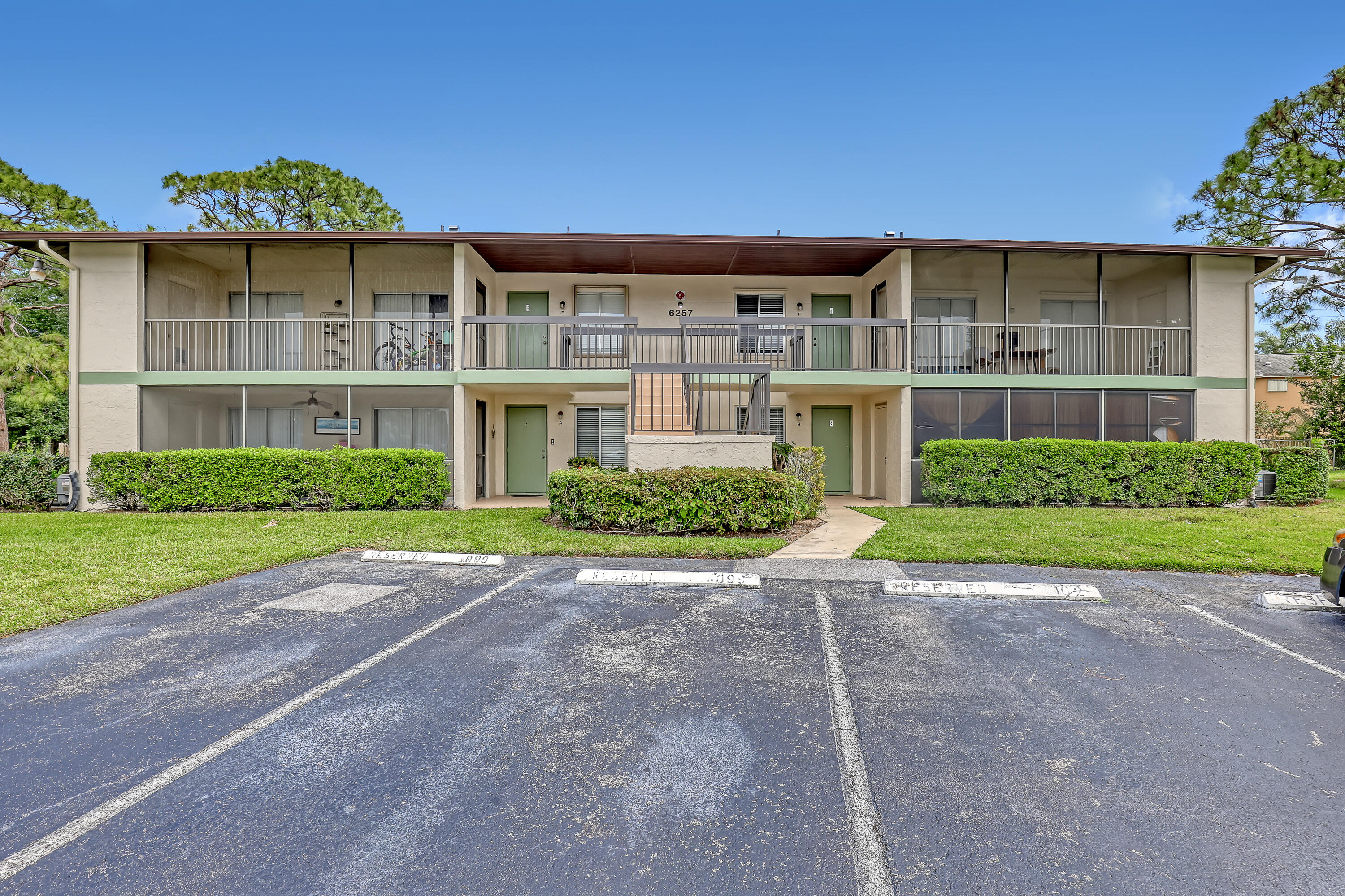 6257 Chasewood Drive, Unit B Jupiter, FL 33458 - Photo 2 of 36 a front view of a house with a yard and potted plants