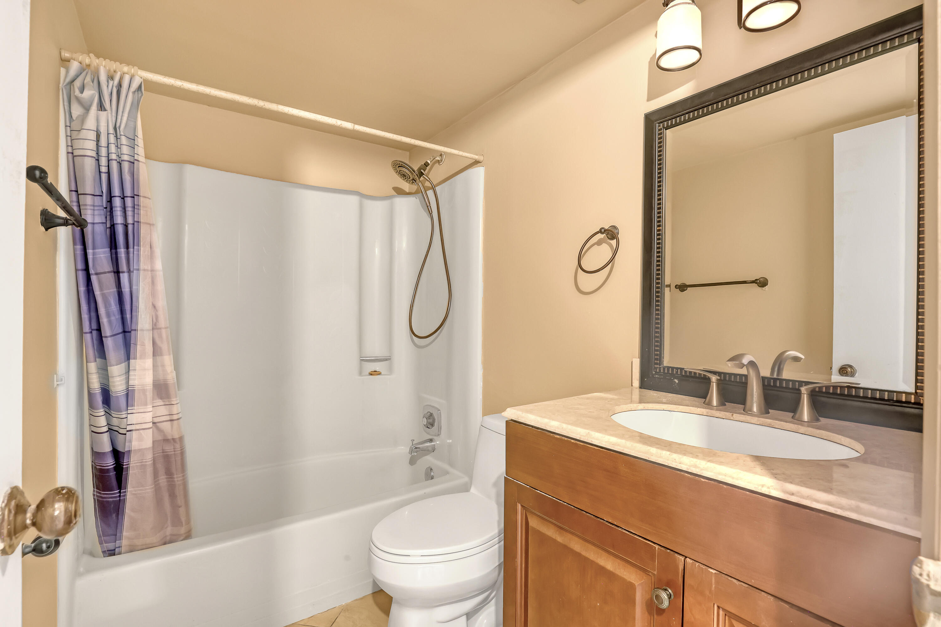 6257 Chasewood Drive, Unit B Jupiter, FL 33458 - Photo 22 of 36 a bathroom with a granite countertop sink toilet and shower