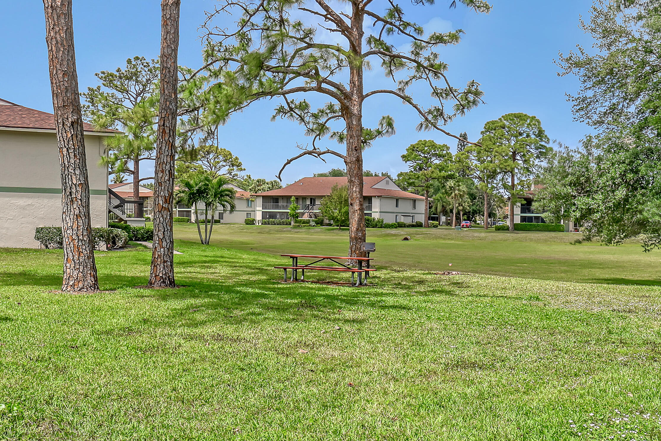 6257 Chasewood Drive, Unit B Jupiter, FL 33458 - Photo 28 of 36 a view of a park with swings and slides