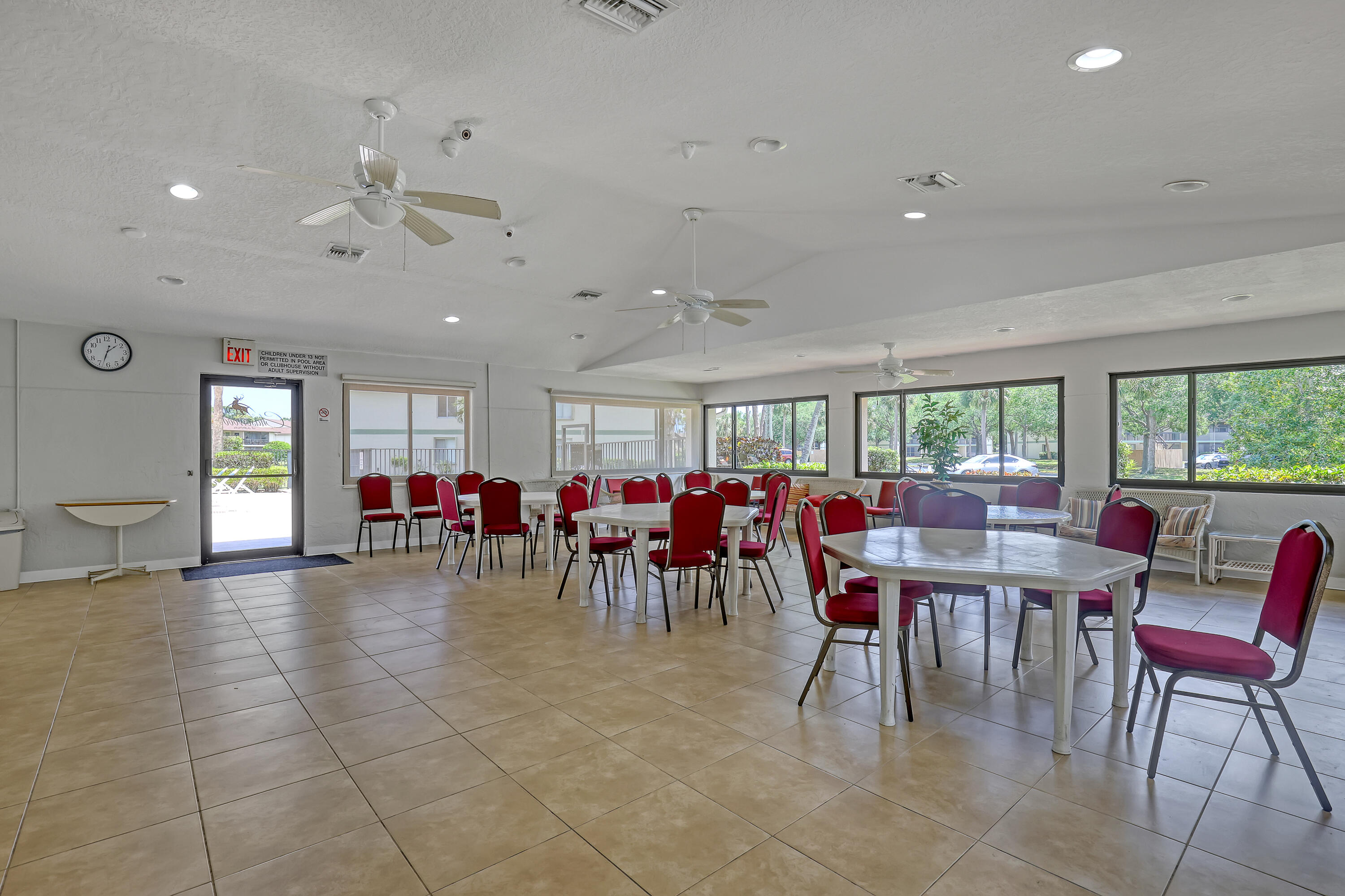 6257 Chasewood Drive, Unit B Jupiter, FL 33458 - Photo 30 of 36 a view of a dining hall with lots of tables and chairs