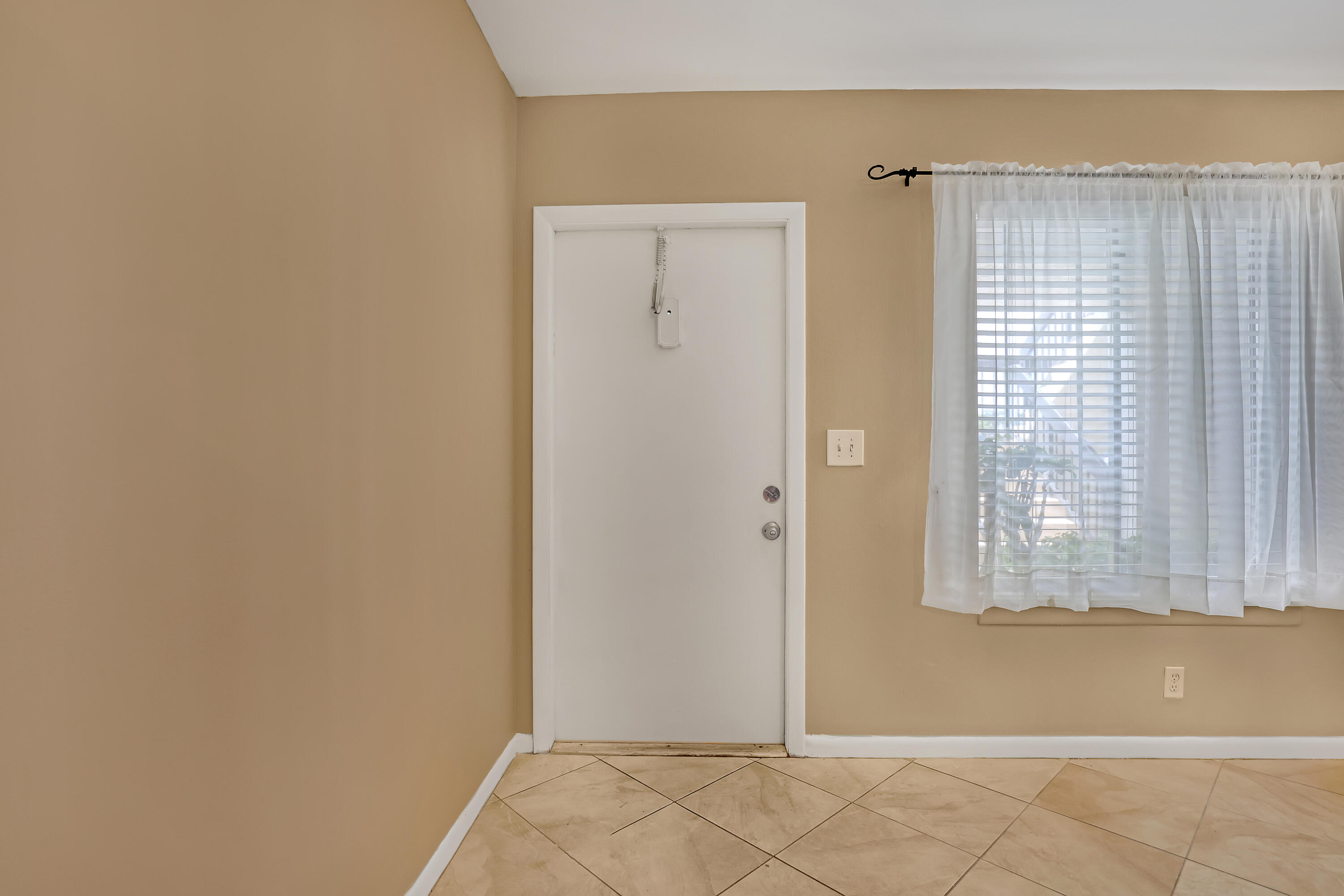 6257 Chasewood Drive, Unit B Jupiter, FL 33458 - Photo 5 of 36 a view of a room that has a window in it