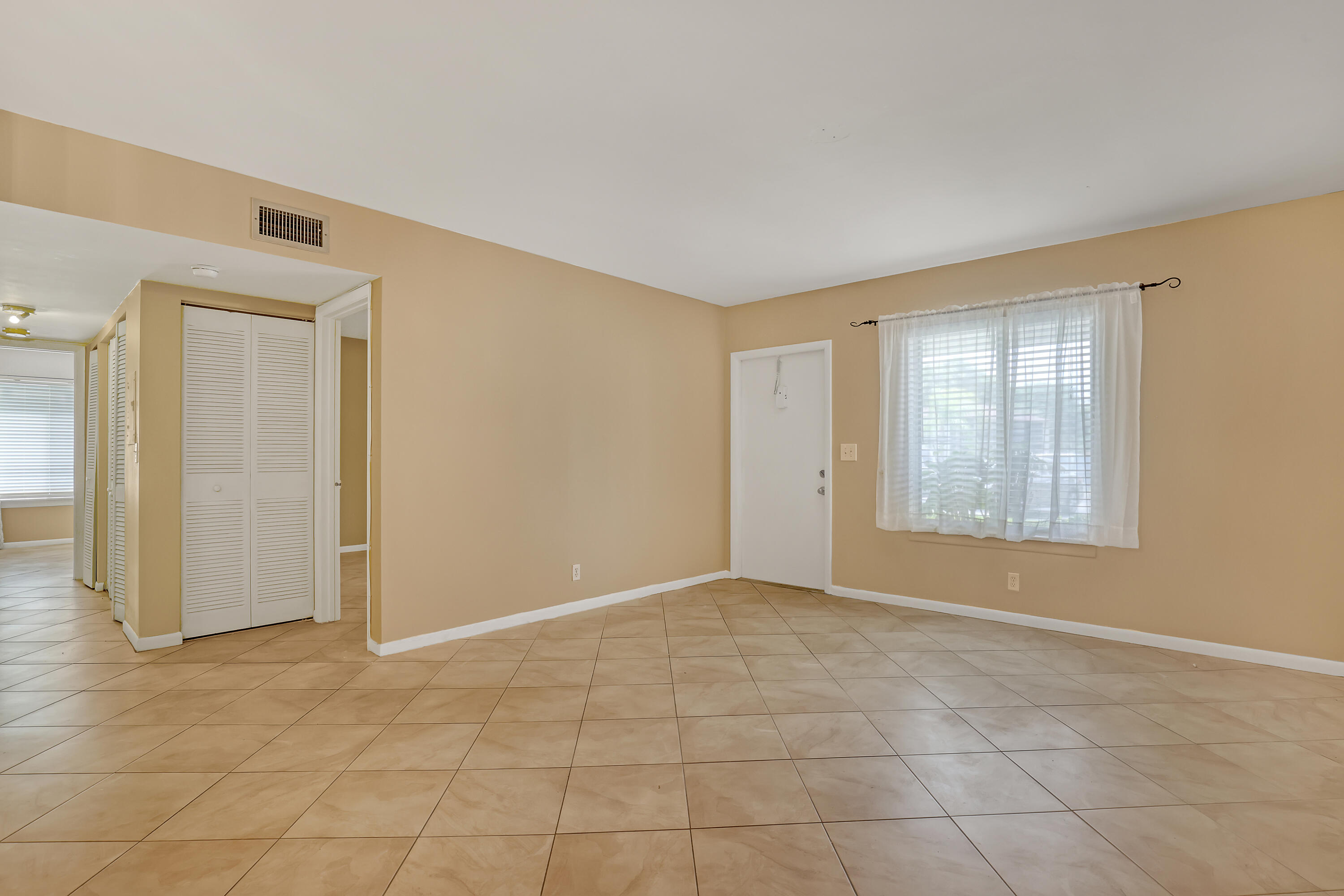 6257 Chasewood Drive, Unit B Jupiter, FL 33458 - Photo 7 of 36 an empty room with windows and closet