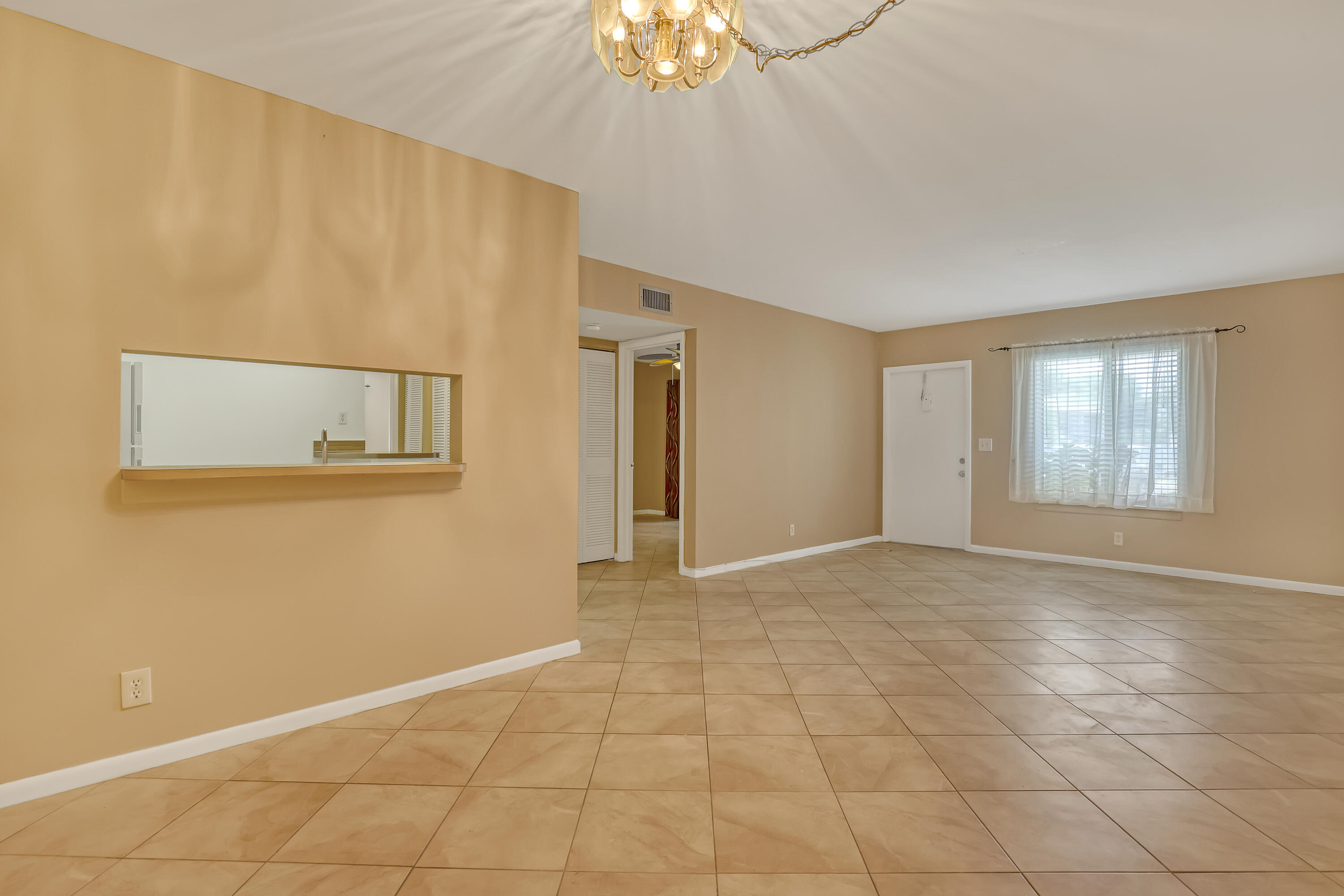 6257 Chasewood Drive, Unit B Jupiter, FL 33458 - Photo 9 of 36 a view of an empty room with a window