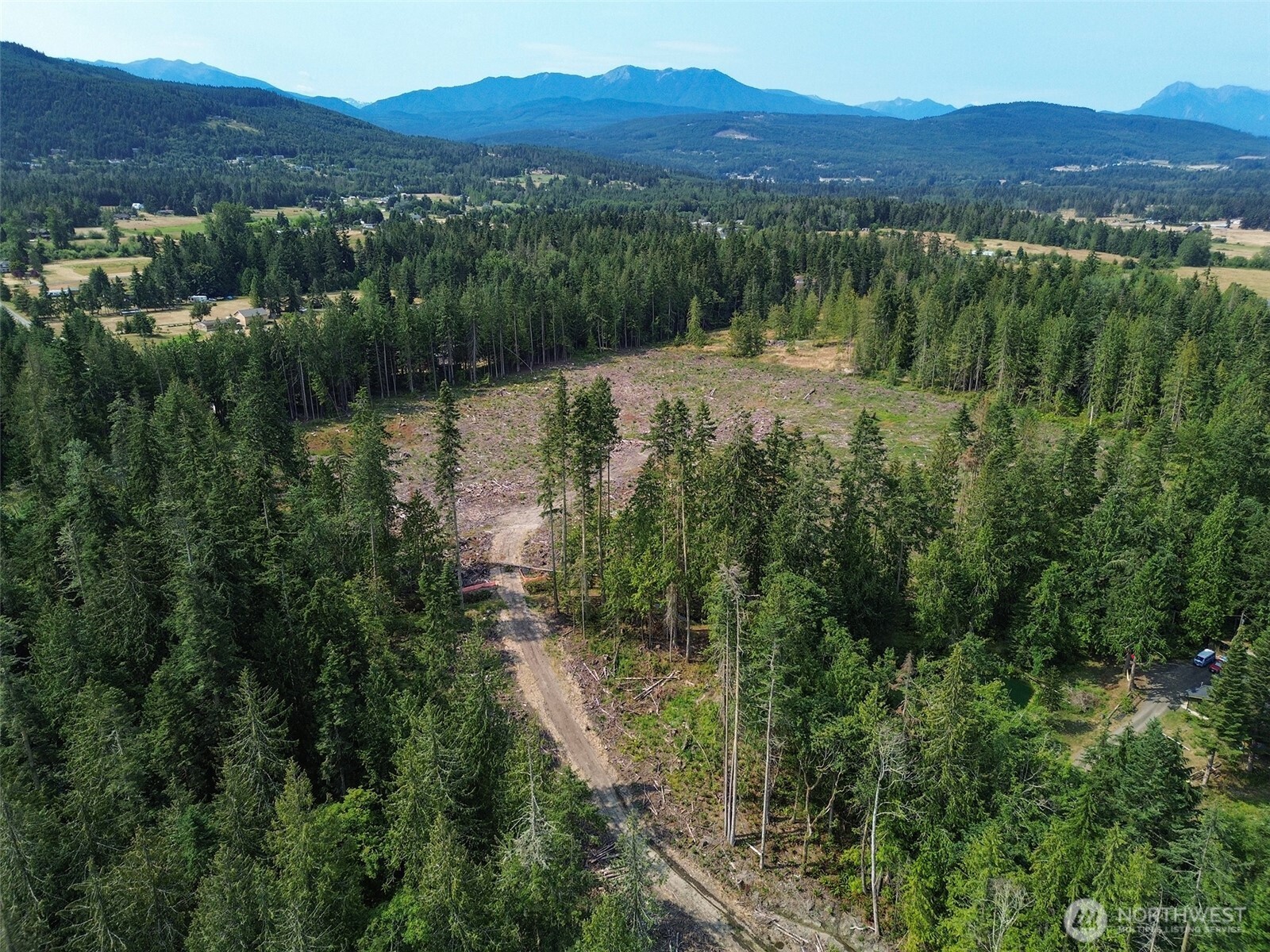 319 Reservoir Road Sequim, WA 98382 - Photo 12 of 38 a view of a lake with mountains in the background