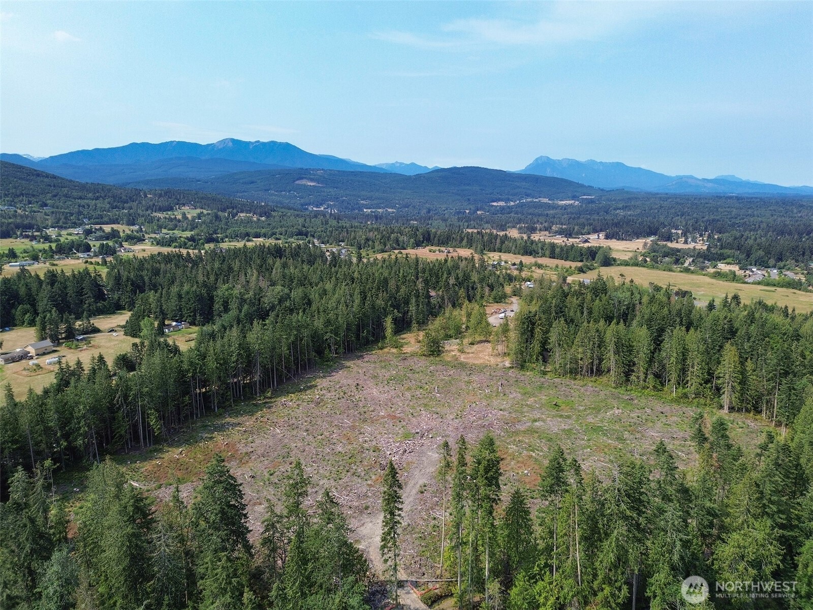 319 Reservoir Road Sequim, WA 98382 - Photo 27 of 38 a view of a town with mountains in the background