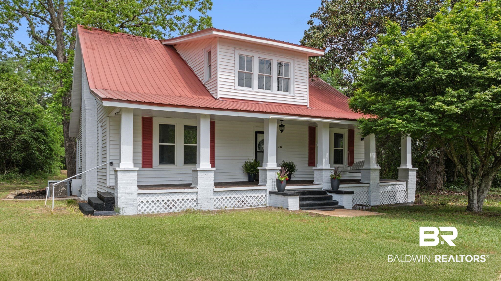 733 Pineville Road Monroeville, AL 36460 - Photo 66 of 68 Bungalow featuring covered porch, metal roof, and a front yard