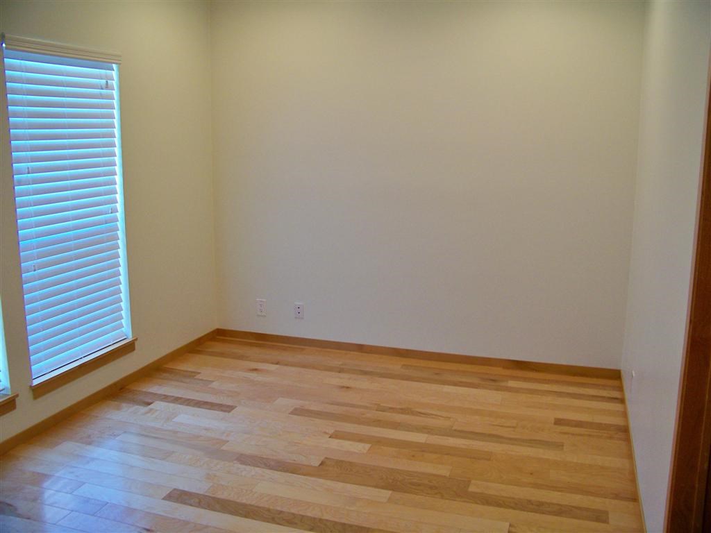 802 South 1st Street, Unit 217 Austin, TX 78704 - Photo 12 of 16 a view of an empty room with wooden floor