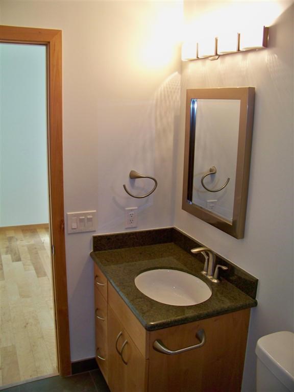 802 South 1st Street, Unit 217 Austin, TX 78704 - Photo 10 of 16 a bathroom with a granite countertop sink and a mirror