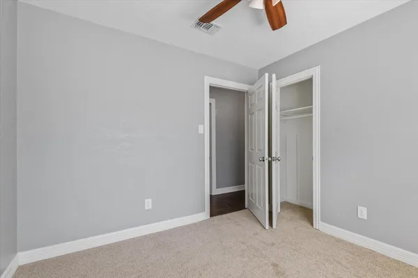 an empty room with ceiling fan
