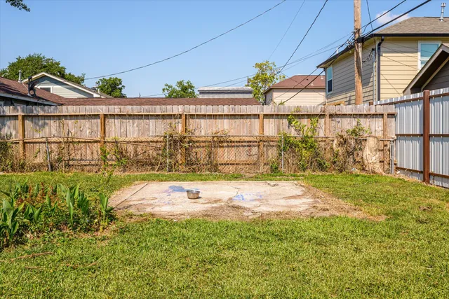a front view of a house with a garden and trees