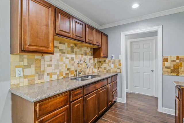 a kitchen with stainless steel appliances granite countertop a sink and cabinets