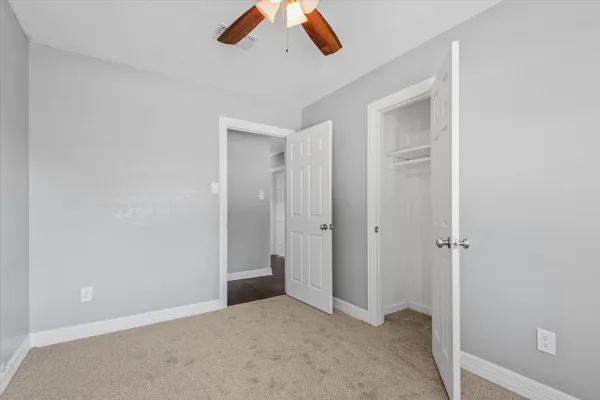 an empty room with closet area