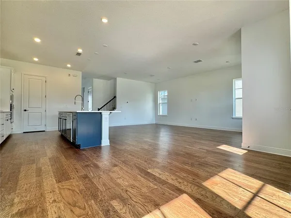 a view of kitchen and hall with wooden floor