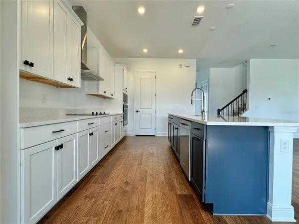 a kitchen with stainless steel appliances sink a microwave and cabinets