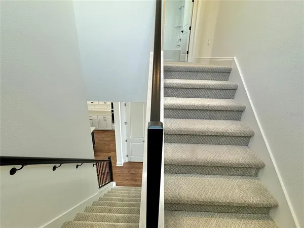a view of staircase with white walls