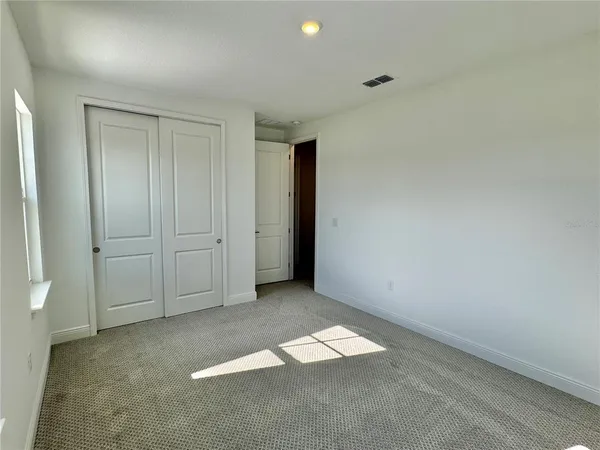 an empty room with closet area