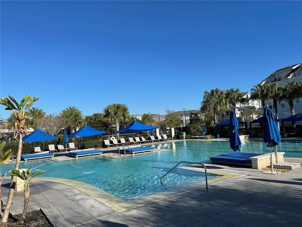 a view of swimming pool with outdoor seating and a garden