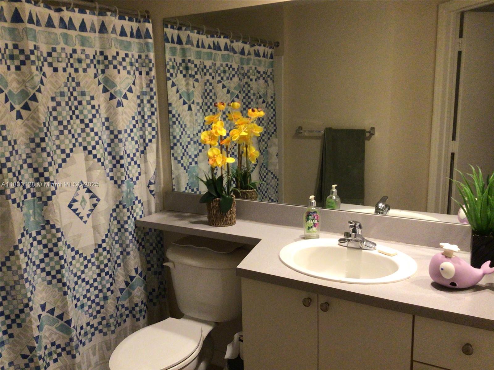 9201 Collins Avenue, Unit 921 Surfside, FL 33154 - Photo 11 of 11 a bathroom with a sink toilet and mirror