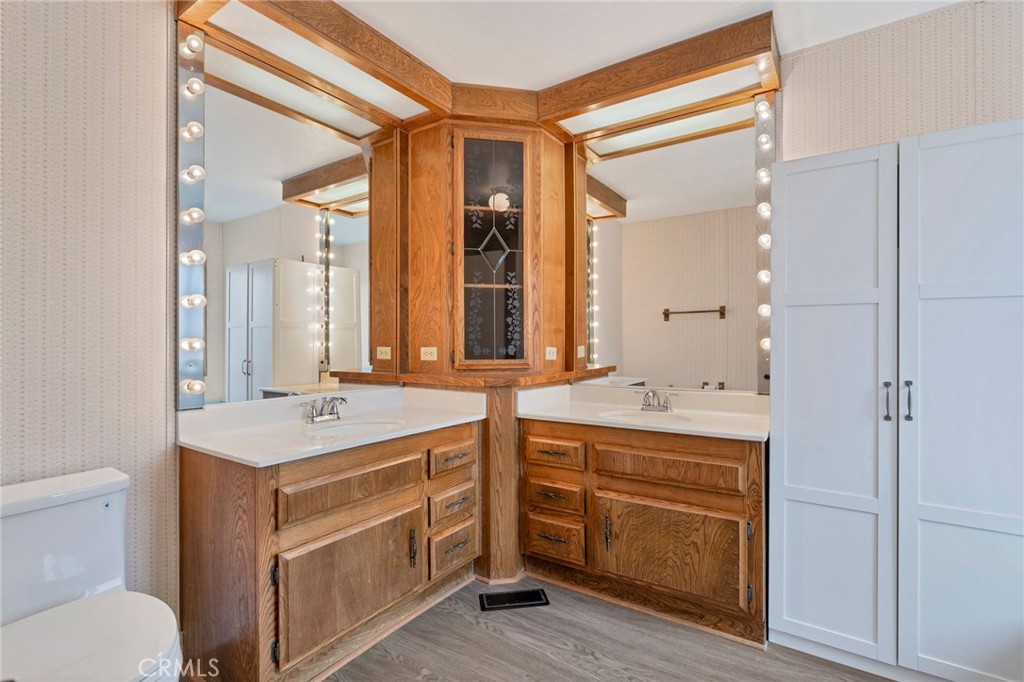 24800 Cornstalk Road Wildomar, CA 92595 - Photo 13 of 19 a bathroom with a granite countertop sink mirror vanity and toilet