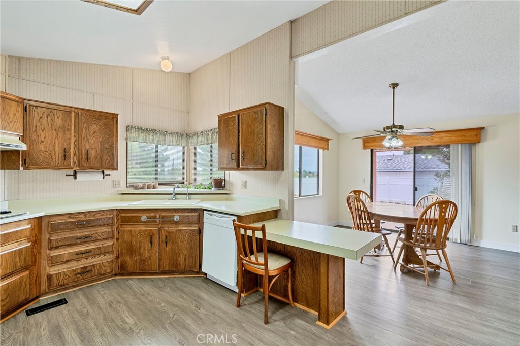 24800 Cornstalk Road Wildomar, CA 92595 - Photo 4 of 19 a open kitchen with stainless steel appliances granite countertop a dining table chairs and a refrigerator
