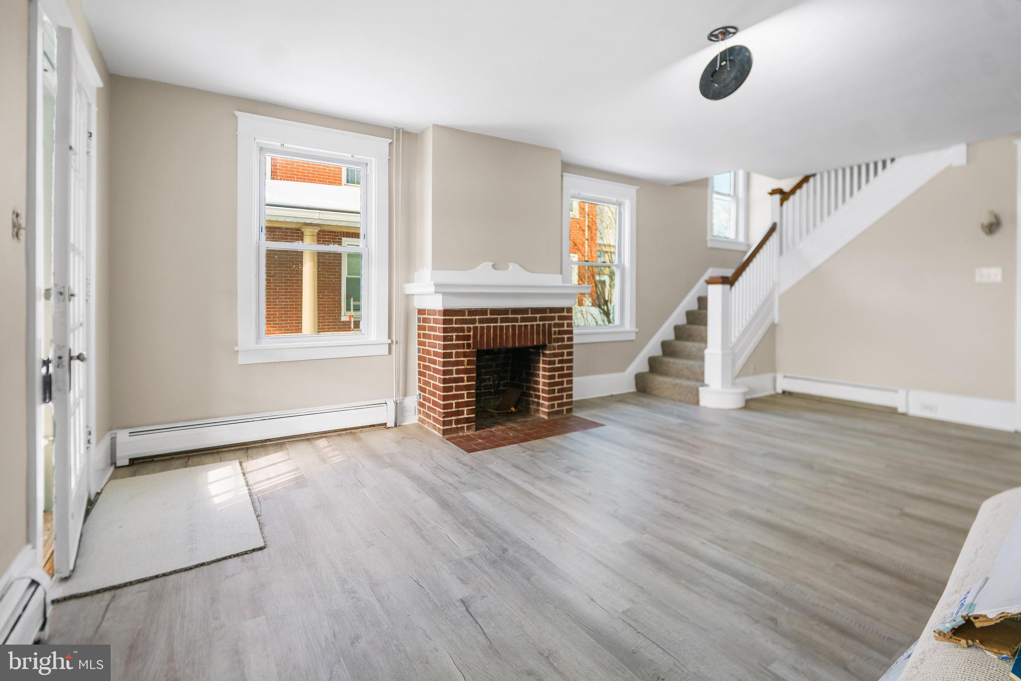 53 Donegal Springs Road Mount Joy, PA 17552 - Photo 4 of 16 a view of empty room with fireplace and wooden floor