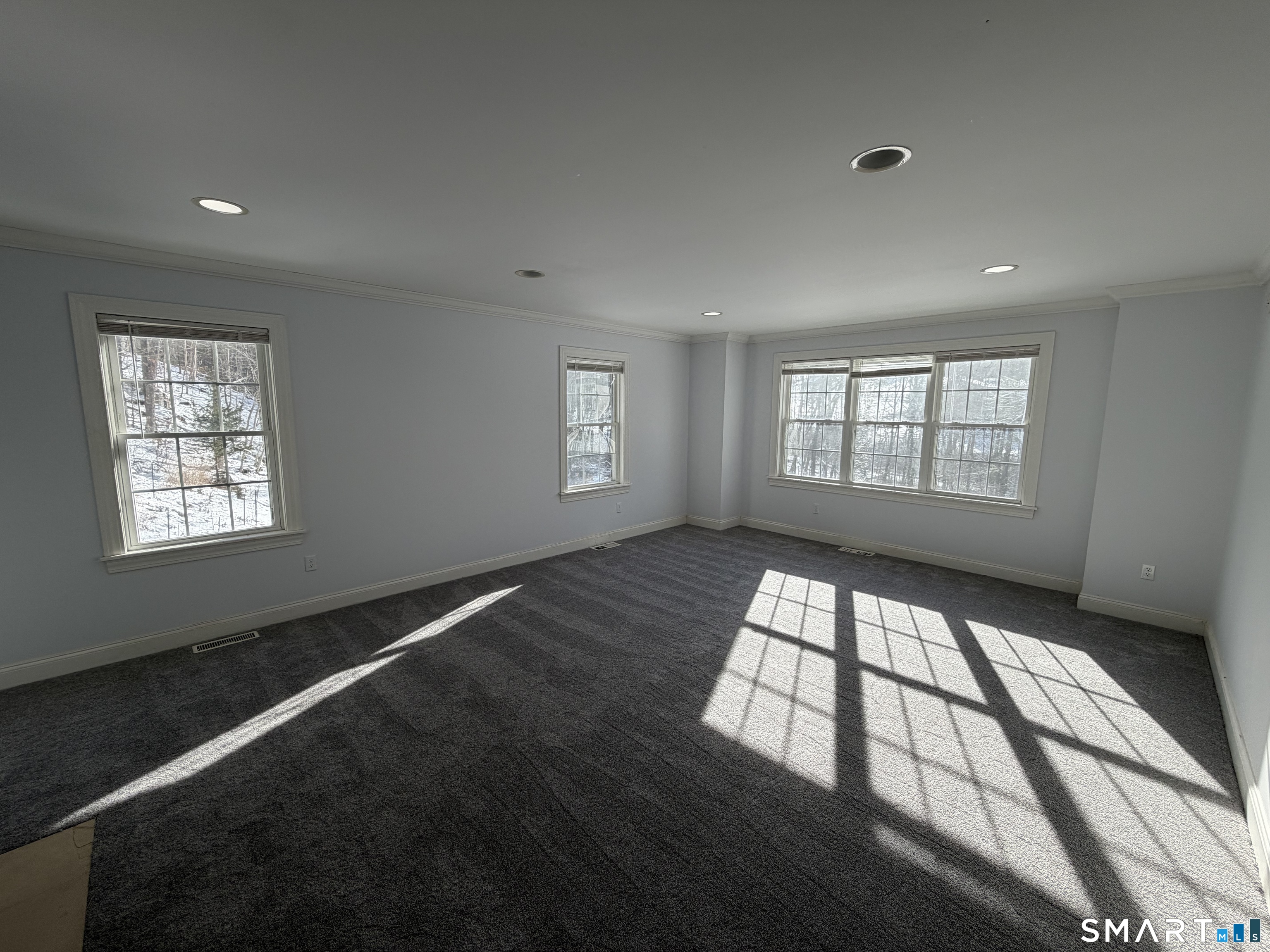 55 A Butterfield Road Newtown, CT 06470 - Photo 18 of 33 an empty room with wooden floor and windows