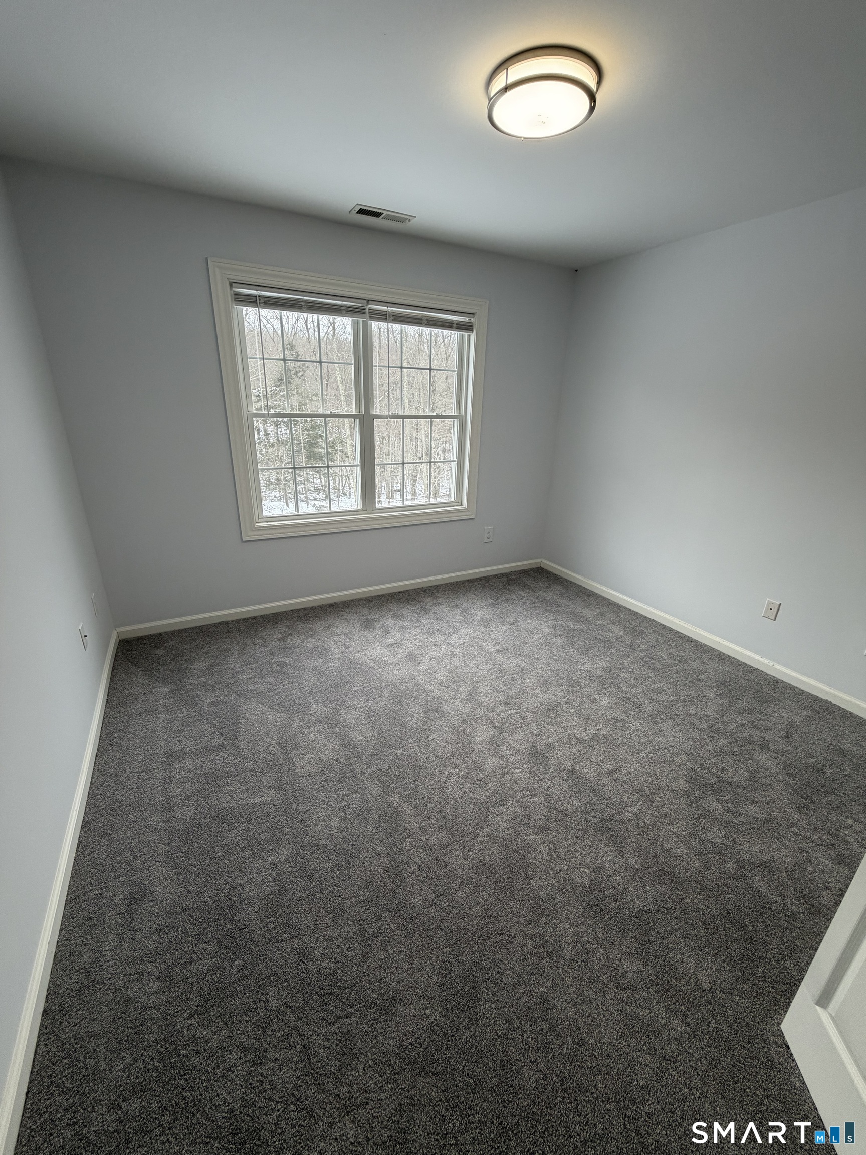 55 A Butterfield Road Newtown, CT 06470 - Photo 22 of 33 an empty room with a window
