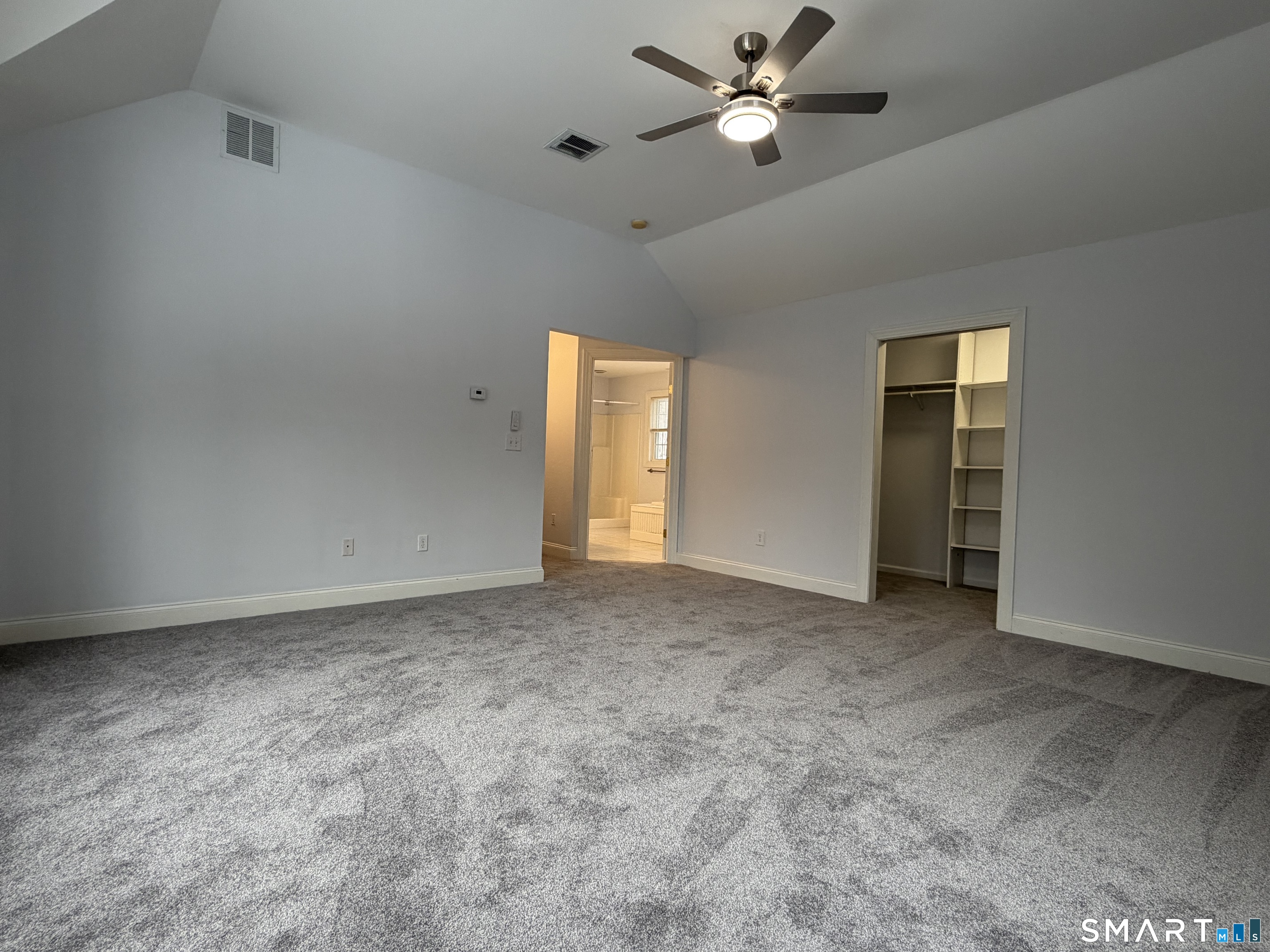 55 A Butterfield Road Newtown, CT 06470 - Photo 29 of 33 an empty room with a ceiling fan and a window
