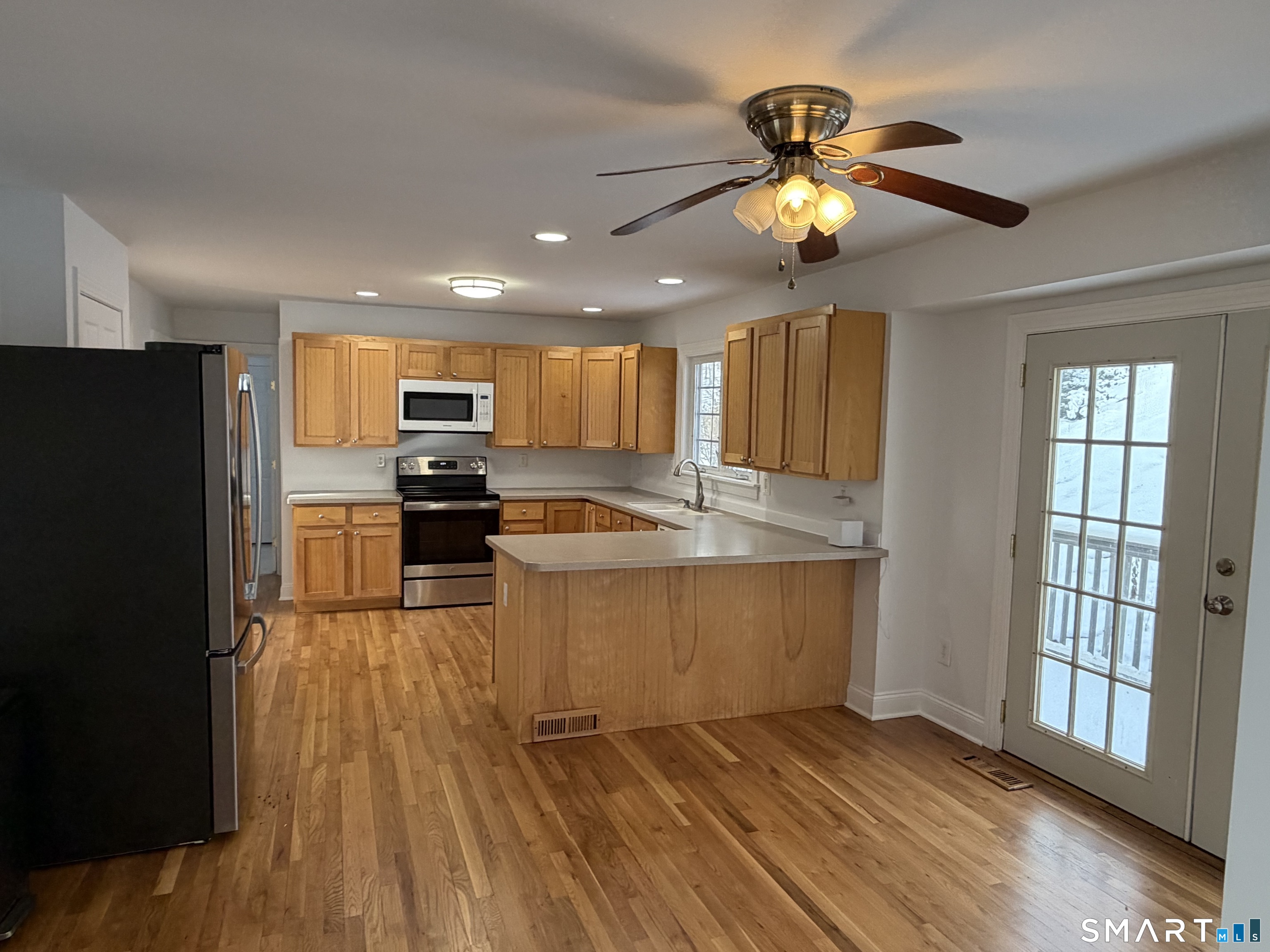 55 A Butterfield Road Newtown, CT 06470 - Photo 9 of 33 a view of kitchen with sink microwave and refrigerator
